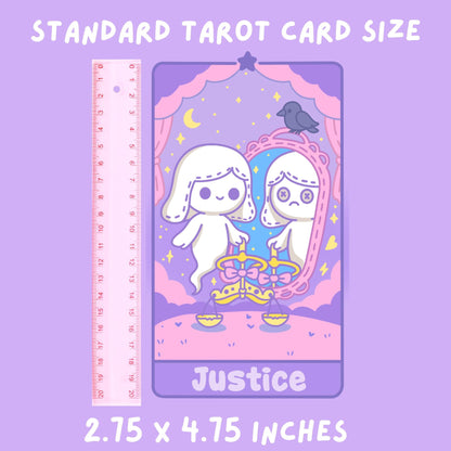Standard tarot card size guide showing the Justice card from the DefaultKawaii tarot deck next to a pink ruler. The card measures 2.75 x 4.75 inches and features two stitched white ghosts with scales, a mirror reflection, a black raven, and pink curtains on a purple starry background
